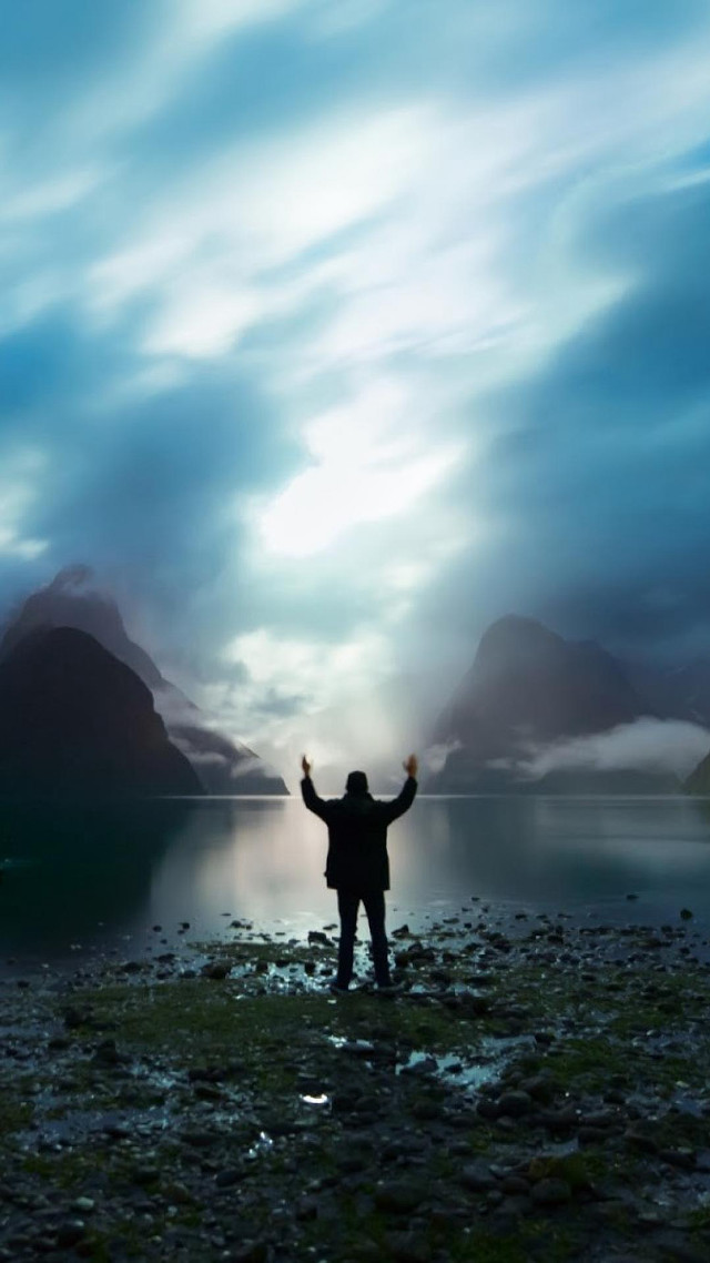 Man beach arms up mountains free wallpaper for mobile - medium preview image