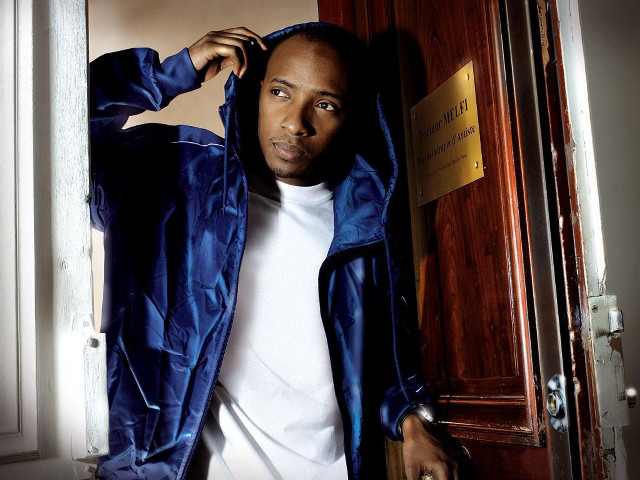 Man blue jacket leaning door free wallpaper for desktop - medium preview image