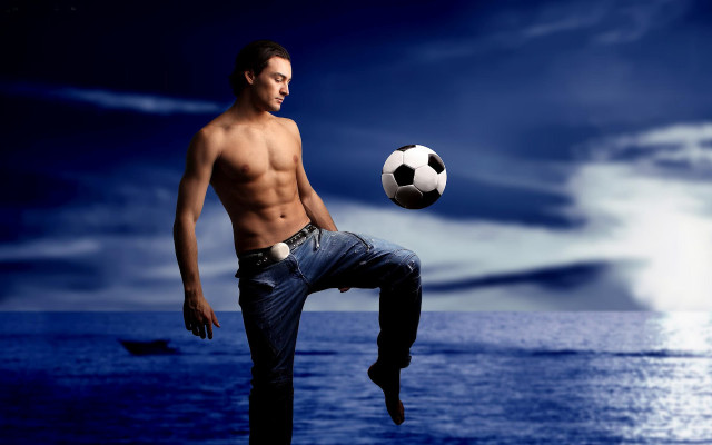 Man kicking soccer ball ocean free wallpaper for desktop - medium preview image