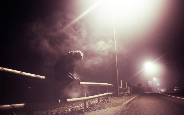 Person sitting rail night streetlight free wallpaper for desktop - medium preview image