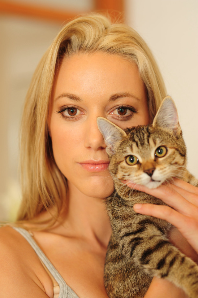 Woman holding cat serious look #2 free wallpaper for mobile - medium preview image