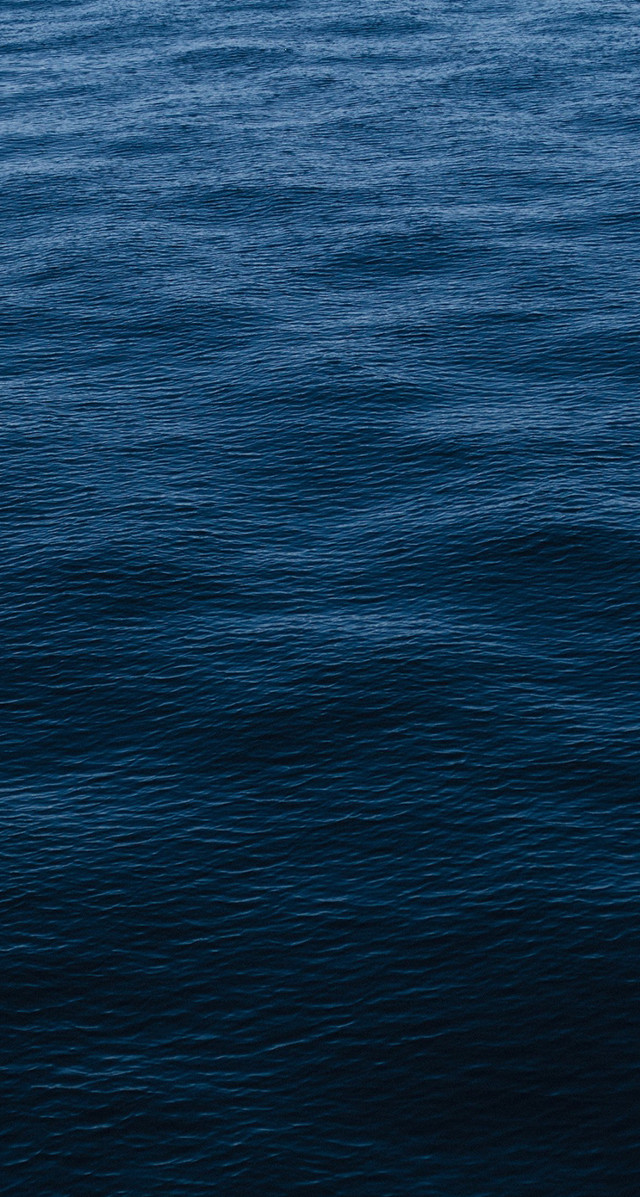 Lone boat ocean sunny blue free wallpaper for mobile - medium preview image