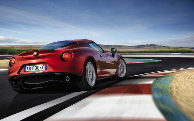 Red sports car driving race free wallpaper for desktop - medium preview image