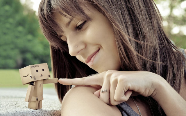 Woman holding wooden toy figure #2 free wallpaper for desktop - medium preview image