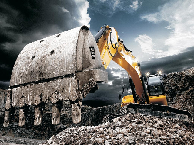 Bulldozer digging rocks cloudy sky free wallpaper for desktop - medium preview image