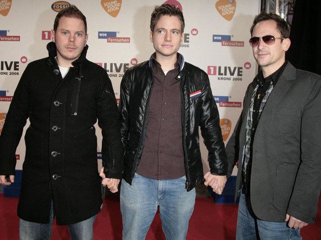 Three men holding hands red free wallpaper for desktop - medium preview image