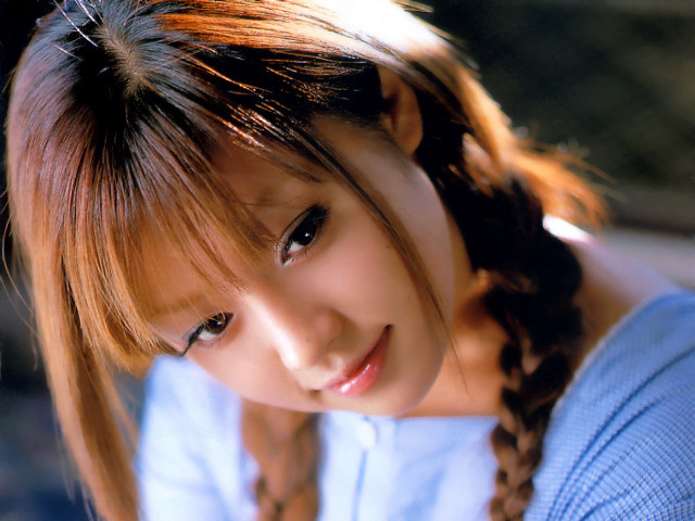 Young woman braid smiling camera free wallpaper for desktop - medium preview image