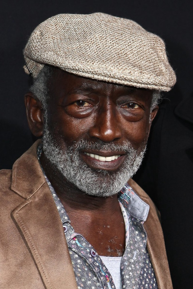 Man hat jacket smiling camera free wallpaper for mobile - medium preview image