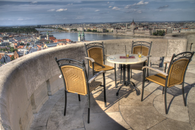 Table chairs balcony cityscape river free wallpaper for desktop - medium preview image
