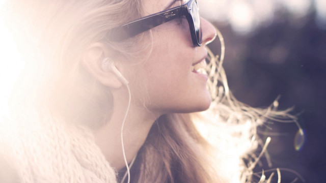 Woman earbuds sunglasses smiling looking free wallpaper for desktop - medium preview image