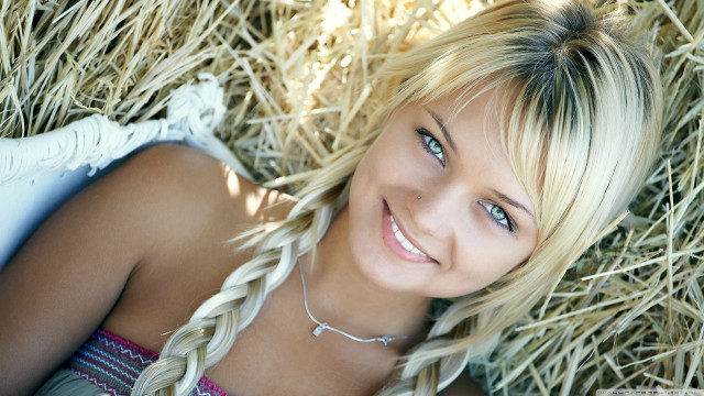 Blond woman hay pile smile free wallpaper for desktop - medium preview image