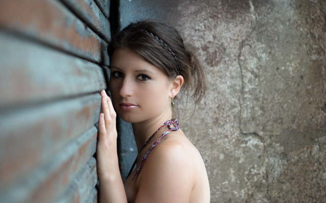 Woman leaning brick wall hand free wallpaper for desktop - medium preview image