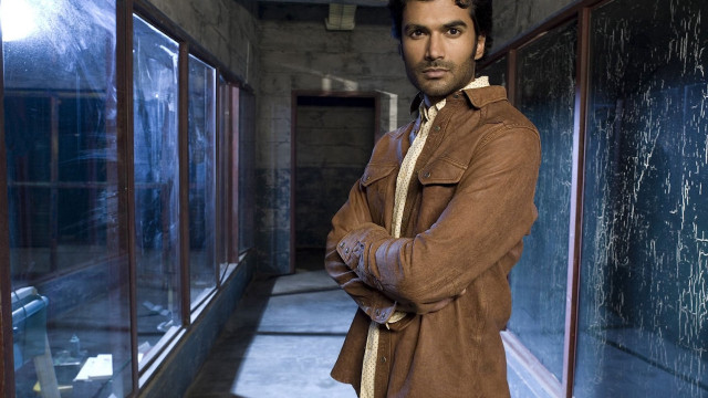 Man standing hallway arms crossed free wallpaper for desktop - medium preview image