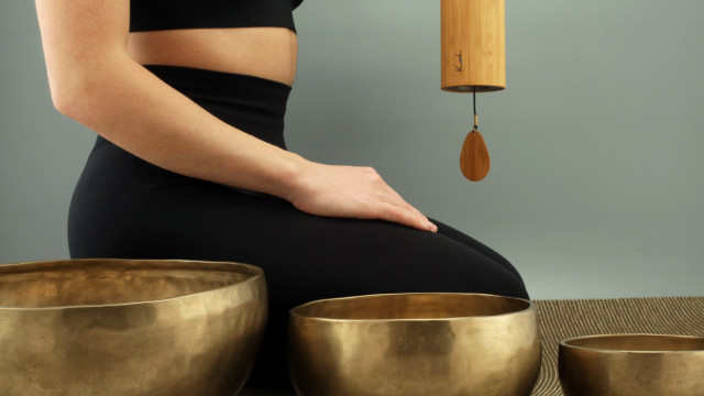 Woman sitting singing bowls pendulum free wallpaper for desktop - medium preview image