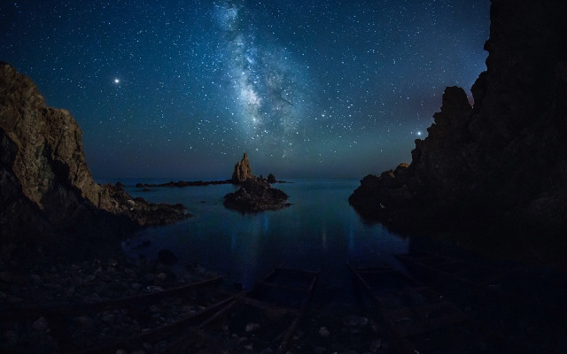 Night sky starry water rocks free wallpaper for desktop - medium preview image