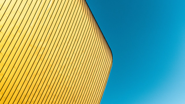 Yellow building blue sky plane free wallpaper for desktop - medium preview image
