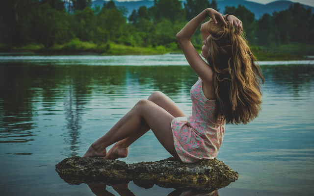 Woman sitting on rock beach free wallpaper for desktop - medium preview image