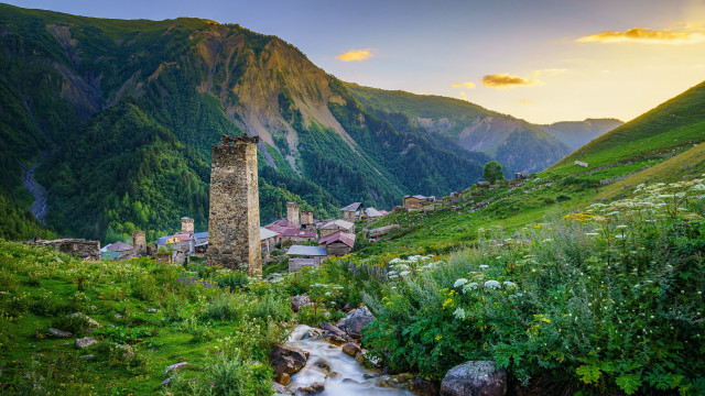 Lush hillside stream tower cloudscape free wallpaper for desktop - medium preview image