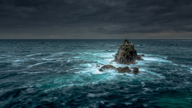 Rock outcropping ocean dark sky free wallpaper for desktop - medium preview image