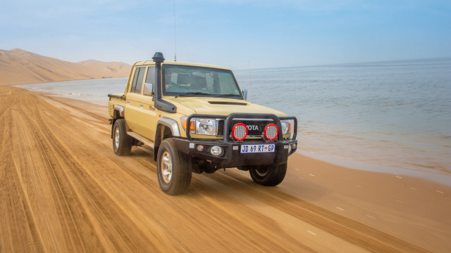 Yellow truck dirt road ocean free wallpaper for desktop - medium preview image