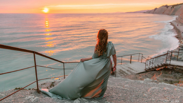 Woman ocean sunset railings mountains free wallpaper for desktop - medium preview image