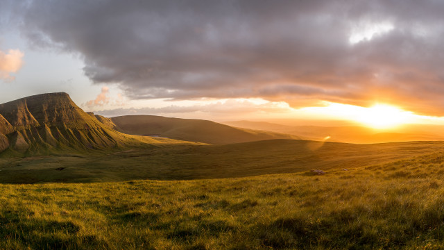 Grassy field mountain sunset sheep free wallpaper for desktop - medium preview image