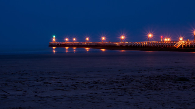Pier lights night beach person free wallpaper for desktop - medium preview image