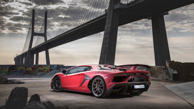 Red sports car bridge clouds free wallpaper for desktop - medium preview image