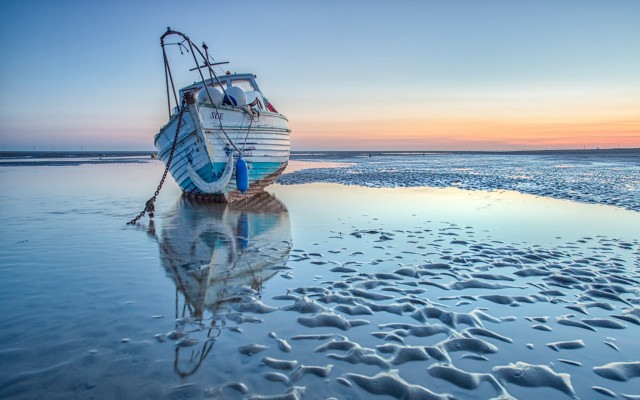 Boat beach sunset footprints ocean free wallpaper for desktop - medium preview image