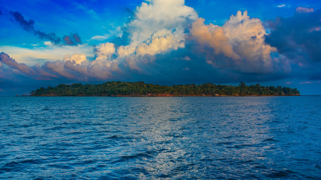 Small island ocean cloudy sky free wallpaper for desktop - medium preview image