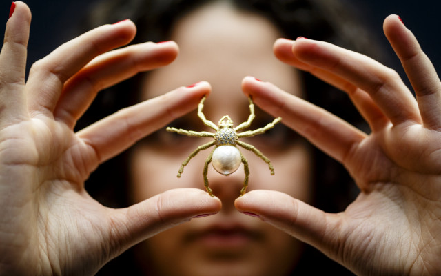 Woman holding spider pearl feminist free wallpaper for desktop - medium preview image