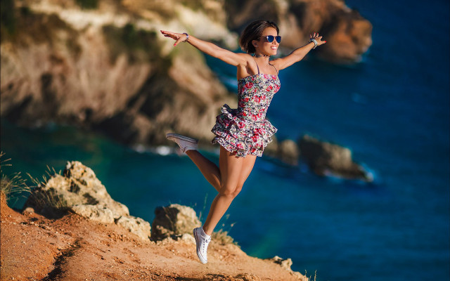 Woman jumping cliff ocean dress free wallpaper for desktop - medium preview image