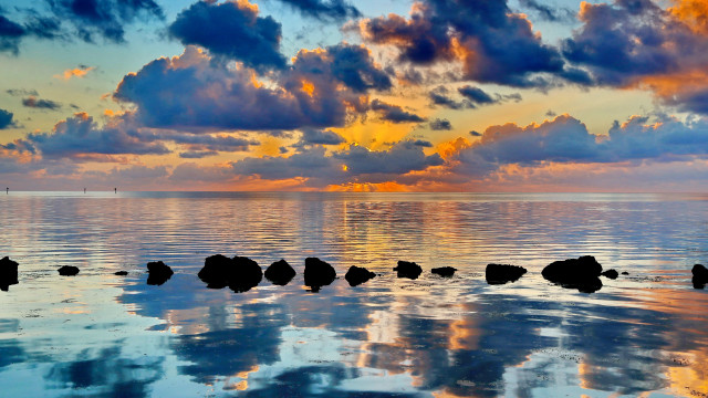 Sunset ocean rocks clouds city free wallpaper for desktop - medium preview image