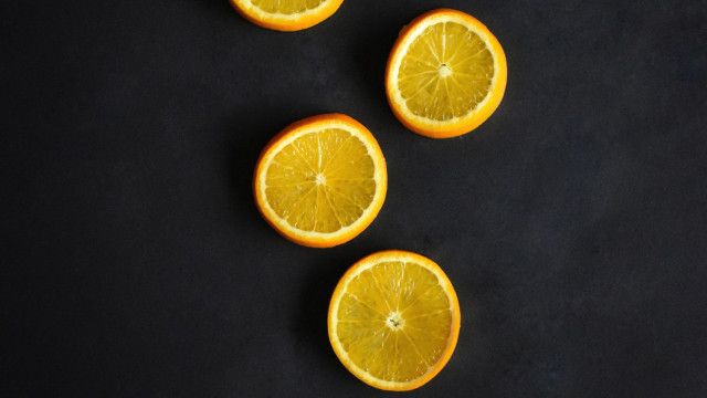 Oranges halved minimalist black surface free wallpaper for desktop - medium preview image