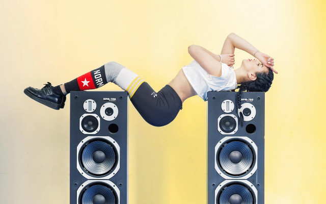 Woman handstand speakers yellow background free wallpaper for desktop - medium preview image