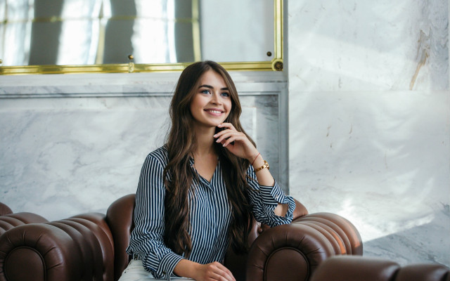 Woman sitting brown leather couch free wallpaper for desktop - medium preview image