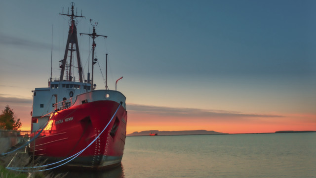 Docked boat sunset mountain water free wallpaper for desktop - medium preview image