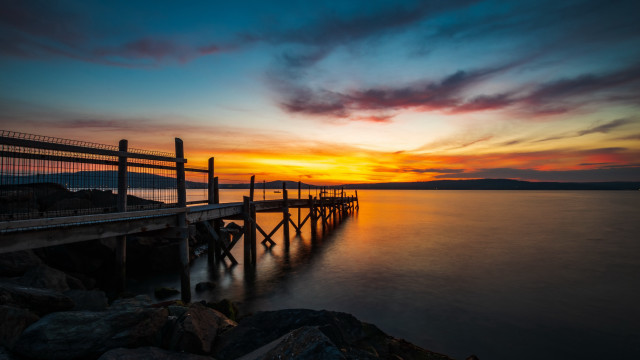 Sunset pier rocks water cityscape free wallpaper for desktop - medium preview image