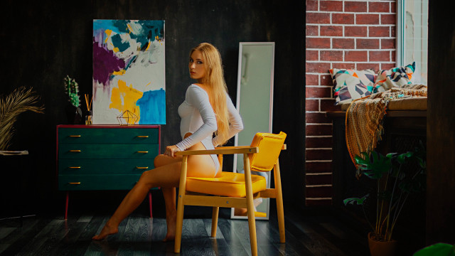 Blonde woman chair brick wall free wallpaper for desktop - medium preview image