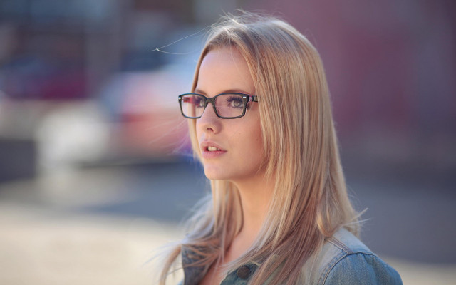 Woman glasses serious portrait blurry free wallpaper for desktop - medium preview image