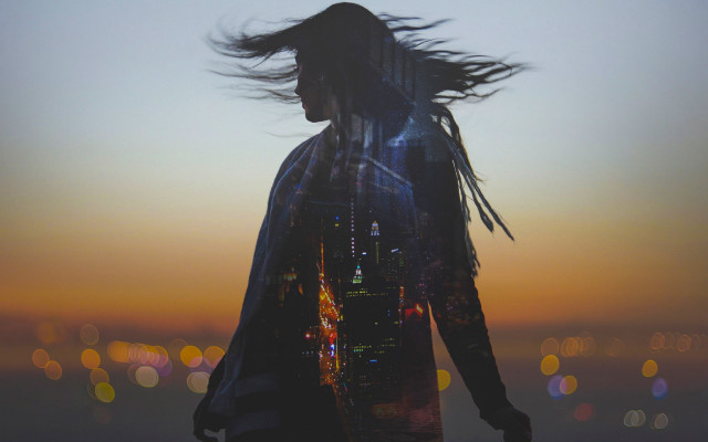 Woman blowing hair city sunset free wallpaper for desktop - medium preview image