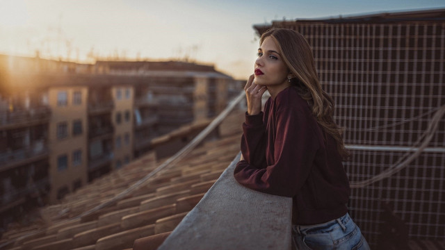 Rooftop cityscape woman blurry background free wallpaper for desktop - medium preview image
