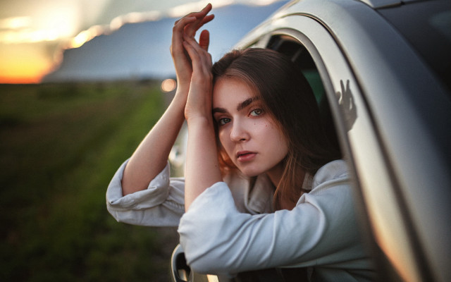 Woman sunset car window blurry free wallpaper for desktop - medium preview image