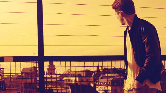 Man balcony laptop city fence free wallpaper for desktop - medium preview image