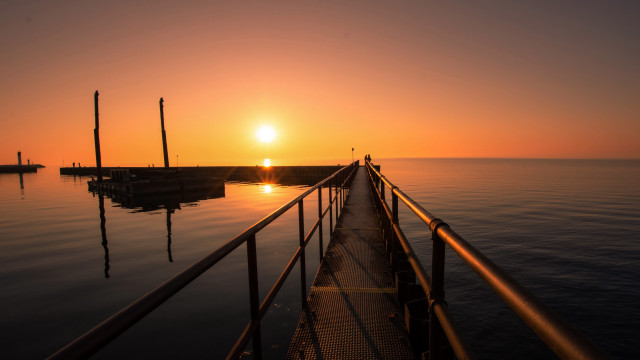 Sunset pier person anamorphic flare free wallpaper for desktop - medium preview image