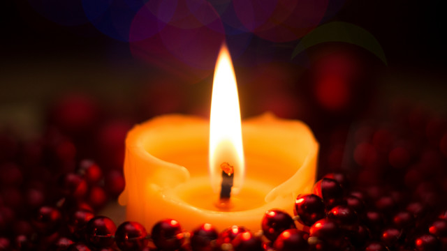 Lit candle red berries bokeh free wallpaper for desktop - medium preview image