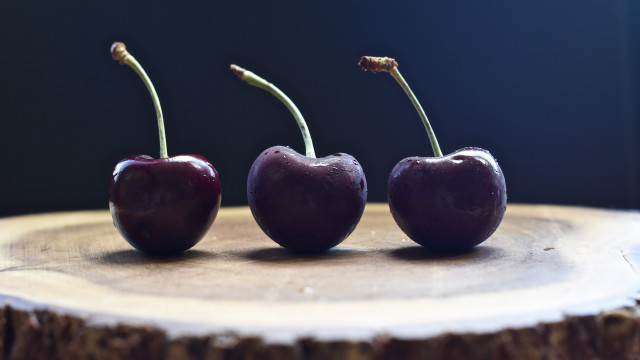 Three cherries on tree stump free wallpaper for desktop - medium preview image