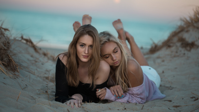 Two women sand relaxing blonde free wallpaper for desktop - medium preview image