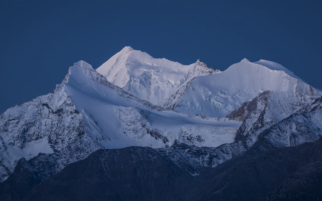Snowy mountain dark sky clouds free wallpaper for desktop - medium preview image
