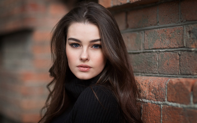 Woman leaning brick wall portrait free wallpaper for desktop - medium preview image